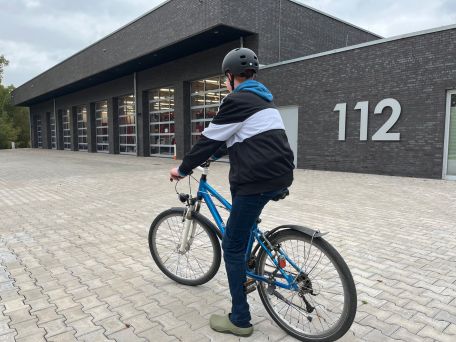 Jugendfeuerwehrangehöriger fährt mit dem Fahrrad zum Feuerwehrdienst